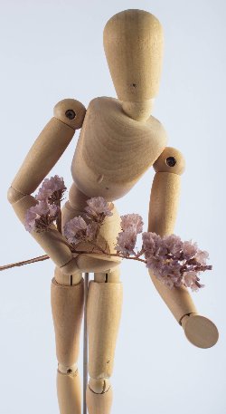 Wooden puppet holding flowers
